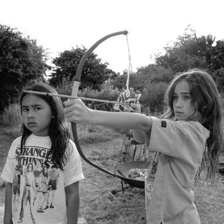 Matewa Kiritapu Waititi and Te Kainga O'Te Hinekahu Waititi are practicing bow and arrow.